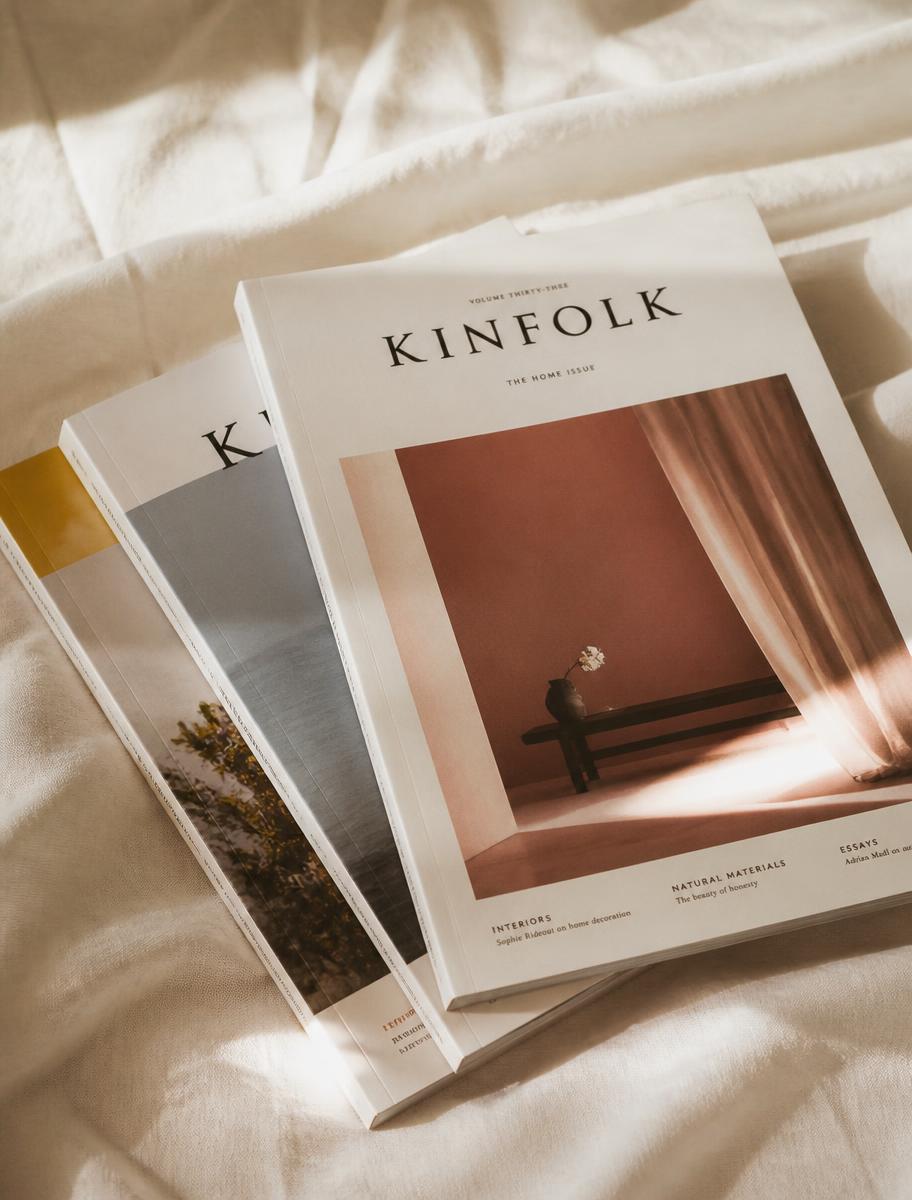 A stack of independent print magazines in soft daylight